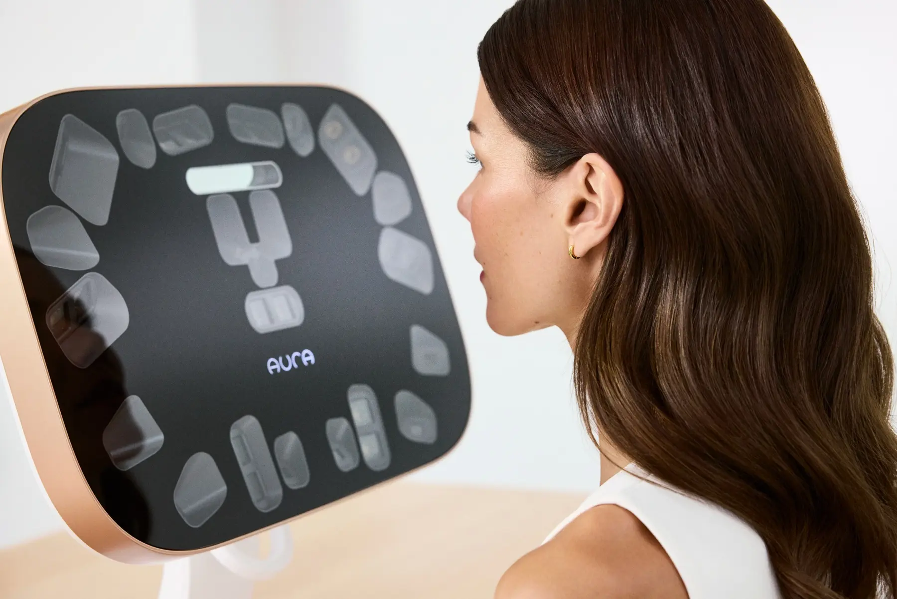 A client positioned in front of the Aura Reality 3D imaging system